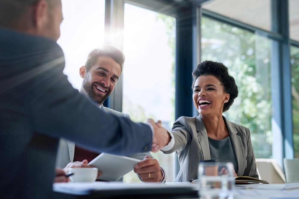 Business partners shaking hands at a meeting
