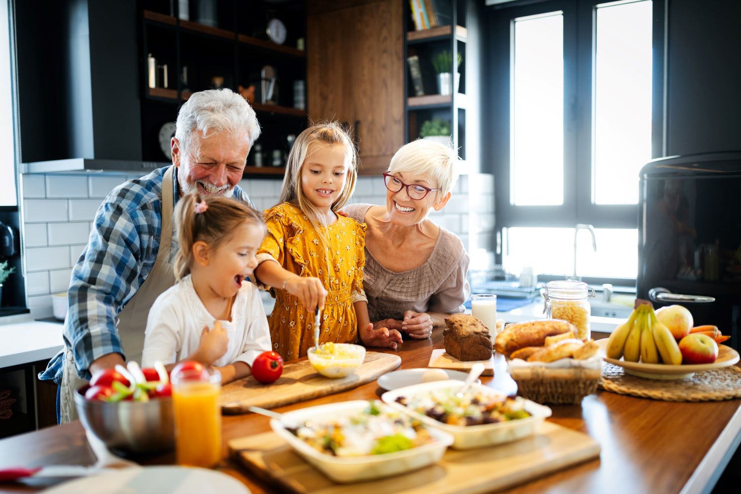 Grandparents making breakfast with their grandchildren 